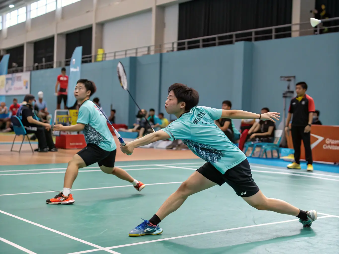 An action shot of adult players engaged in a competitive badminton match, showcasing agility, strategy, and intense gameplay in a professional-grade badminton court.
